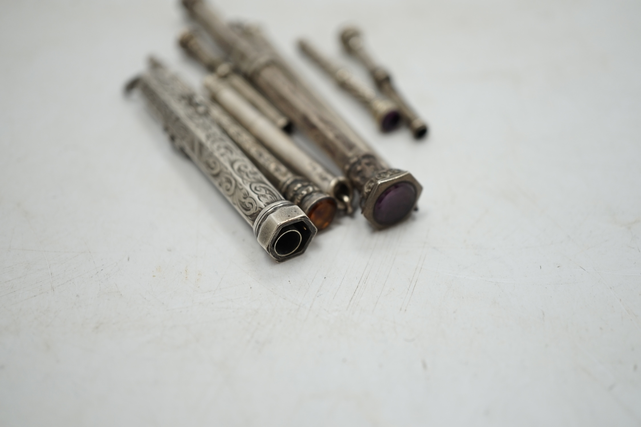 Two sterling cased propelling pencils and six other white metal cased propelling pencils, largest 91mm. Condition - fair